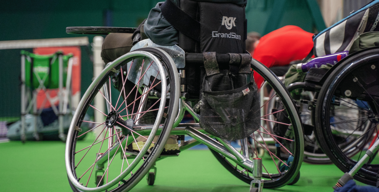 A wheelchair on a tennis court.
