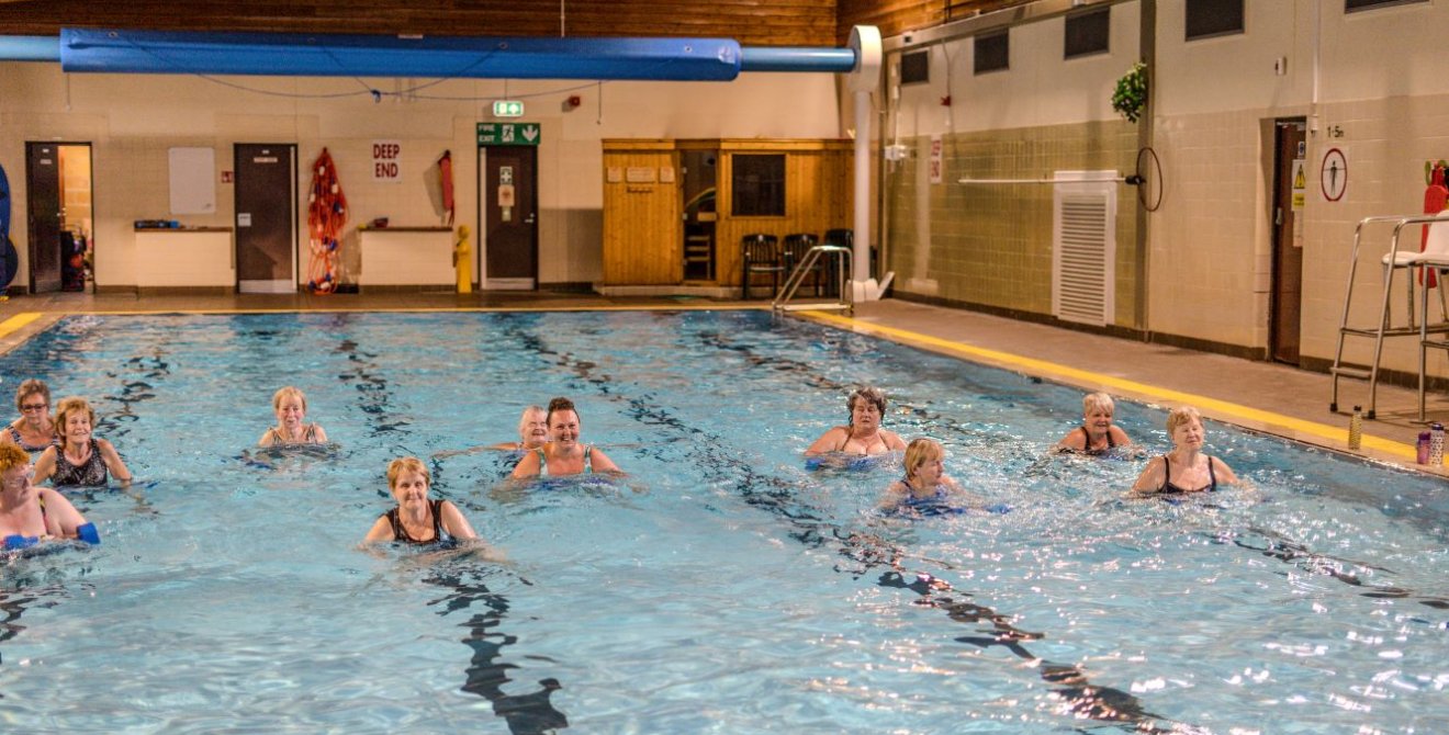 A group of older women exercising in a swimming pool