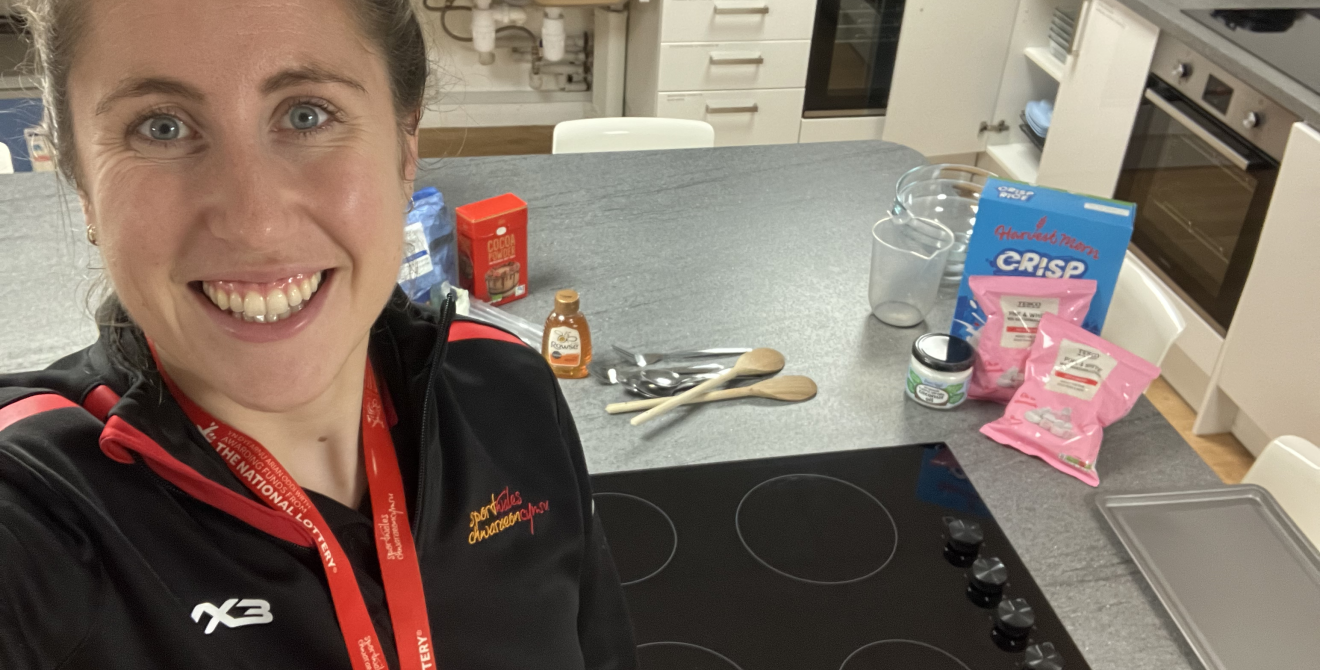 Nancy Lunnon takes a selfie with ingredients and a hob in a kitchen