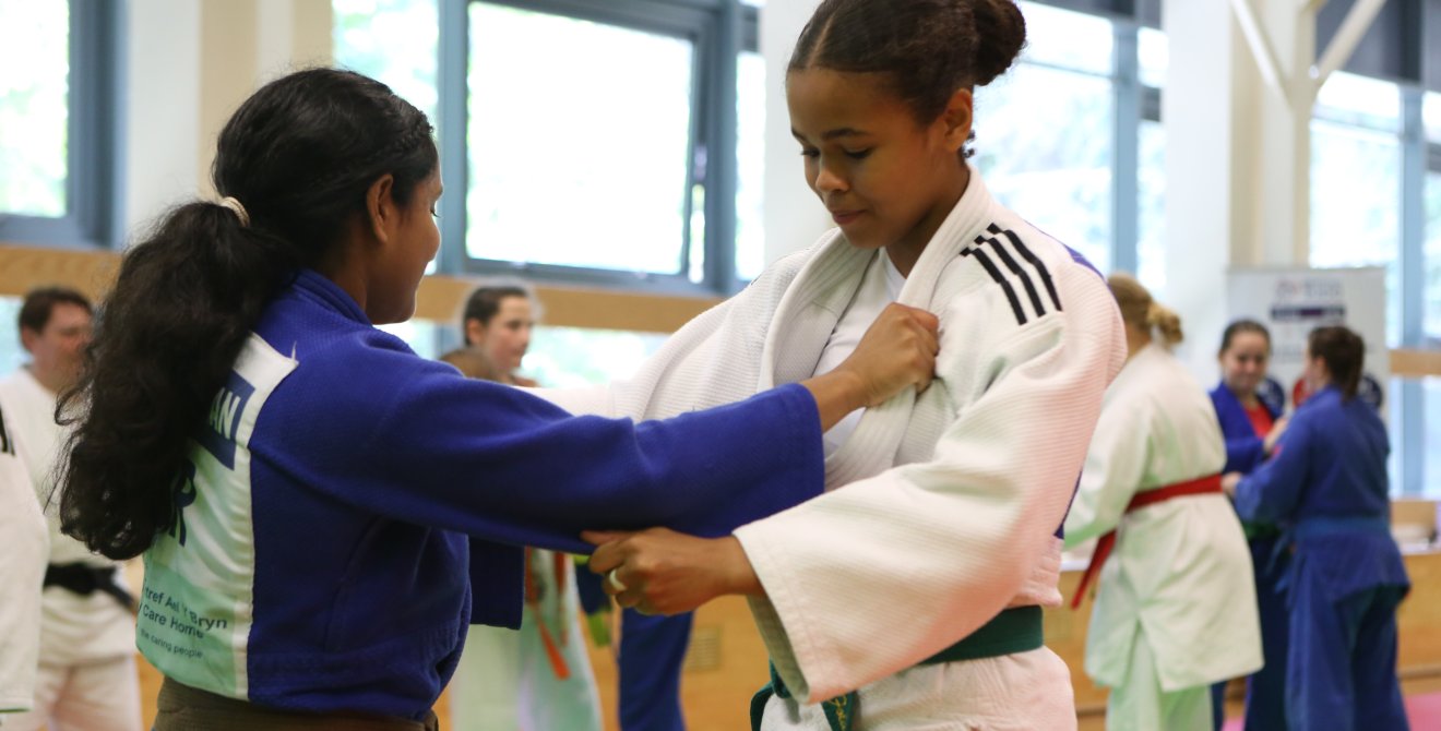 Two girls grabbing each others kit in judo