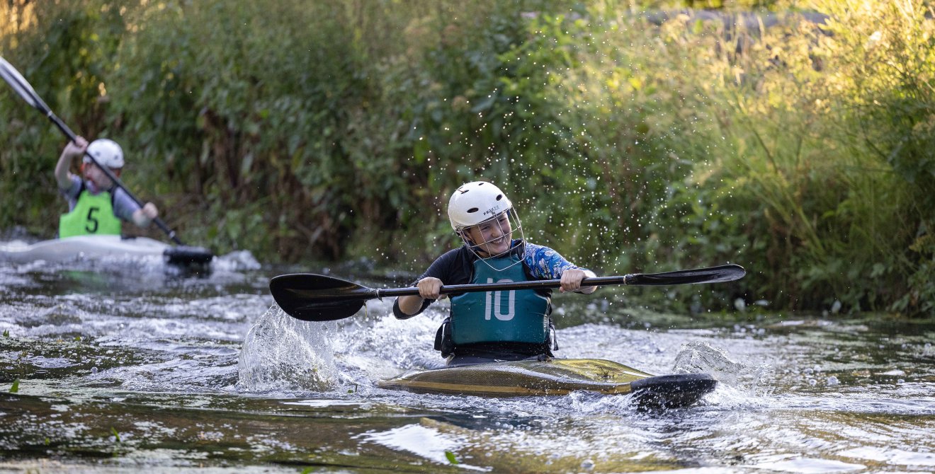 Asher enjoys rowing in the canoe.