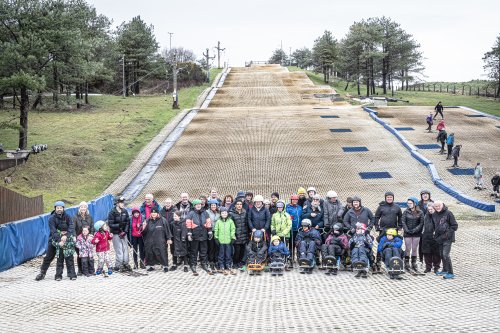 The group of skiers pose for a photo on the slope