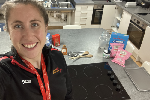 Nancy Lunnon takes a selfie with ingredients and a hob in a kitchen
