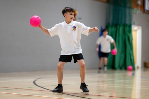 A boy playing dodgeball.