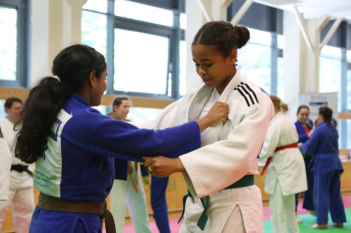 Two girls grabbing each others kit in judo