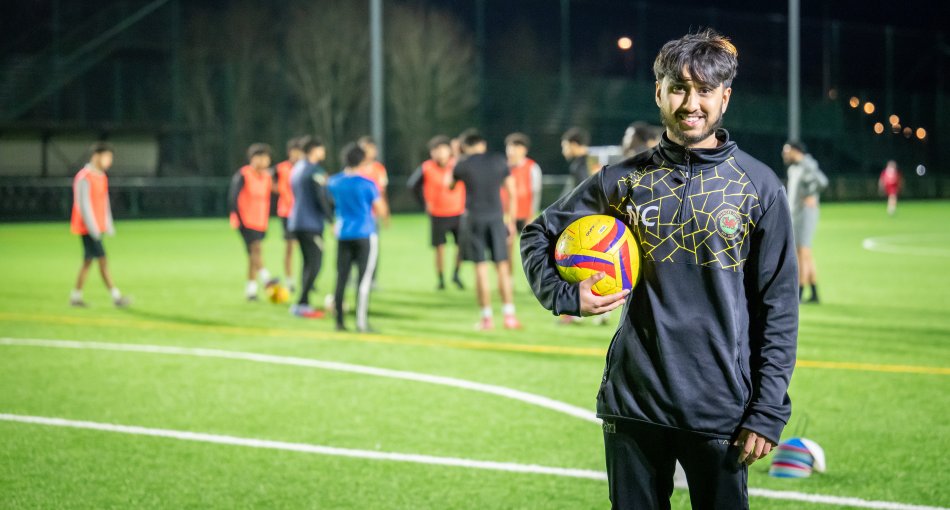 Nasif smiles as he holds one of the new balls at Maindee United training.