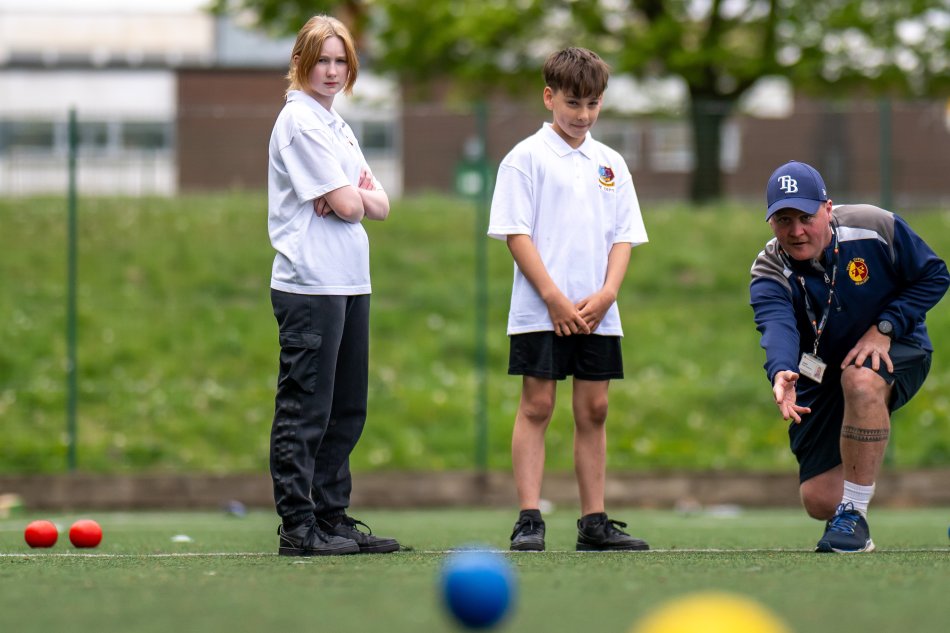 Pupils and a teacher outside at Heolddu Comprehensive School.