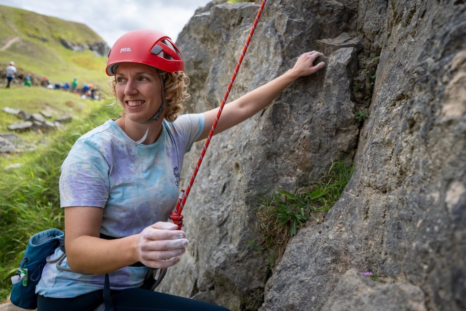 Hannah smiles as she climbs.