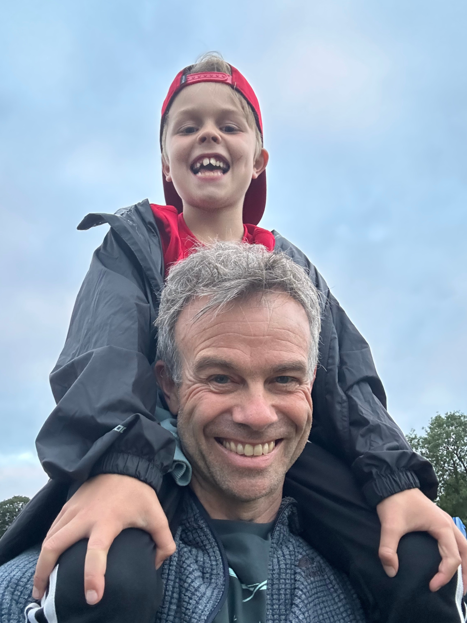 A selfie of Owen with his son on his shoulders